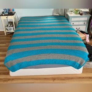 Blue and Gray Striped Handmade Crochet Blanket; Pictured on Queen-Sized Bed